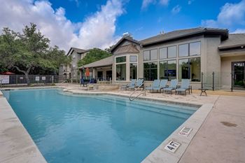 the preserve at ballantyne commons pool with chairs and a building with a pool